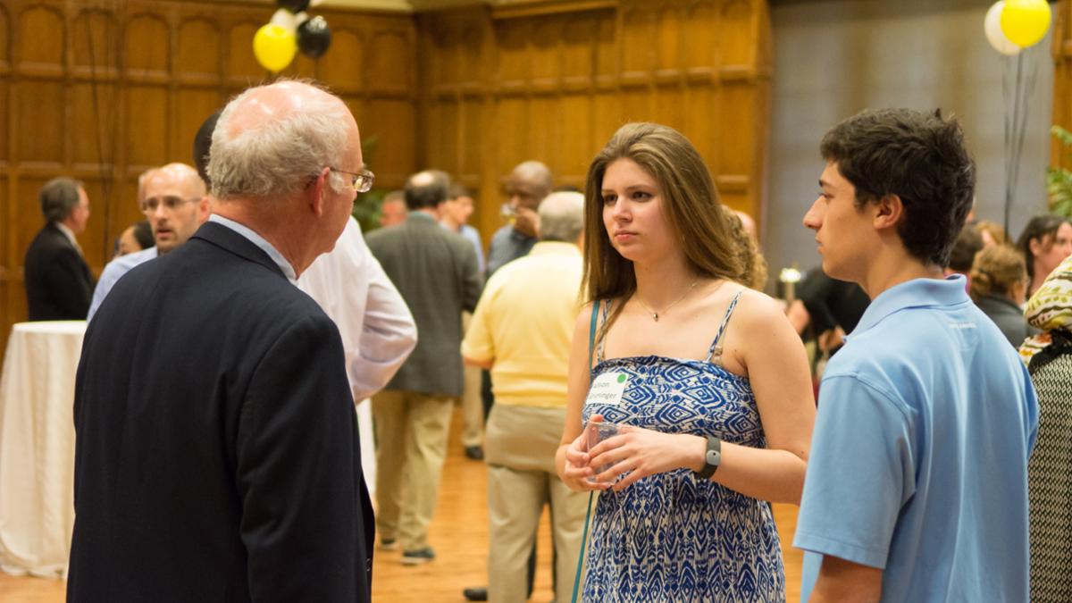 Photo of students and faculty conversing at Favorite Faculty Reception