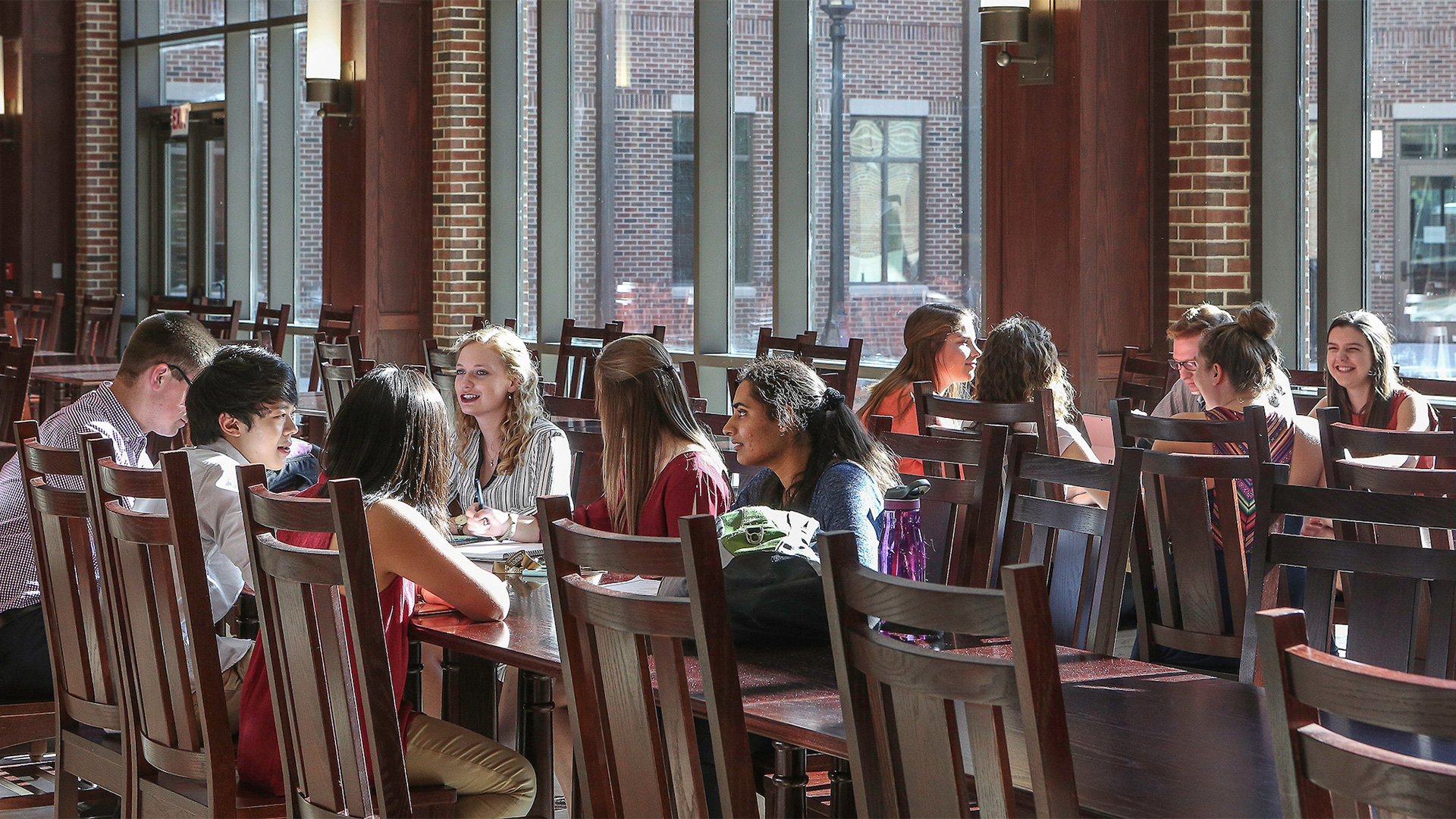 Multiple people talking around a large table.