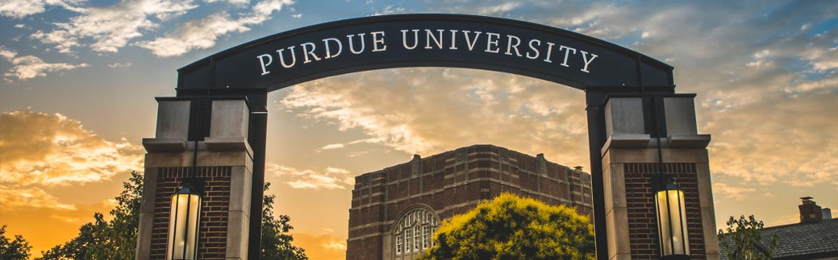 Photo of the sunset through the Purdue University Arch by the Purdue Memorial Union