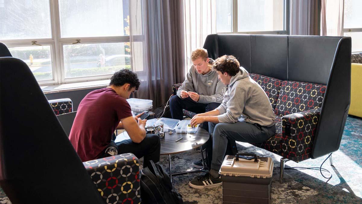 Photo of Purdue students doing school work in residence hall