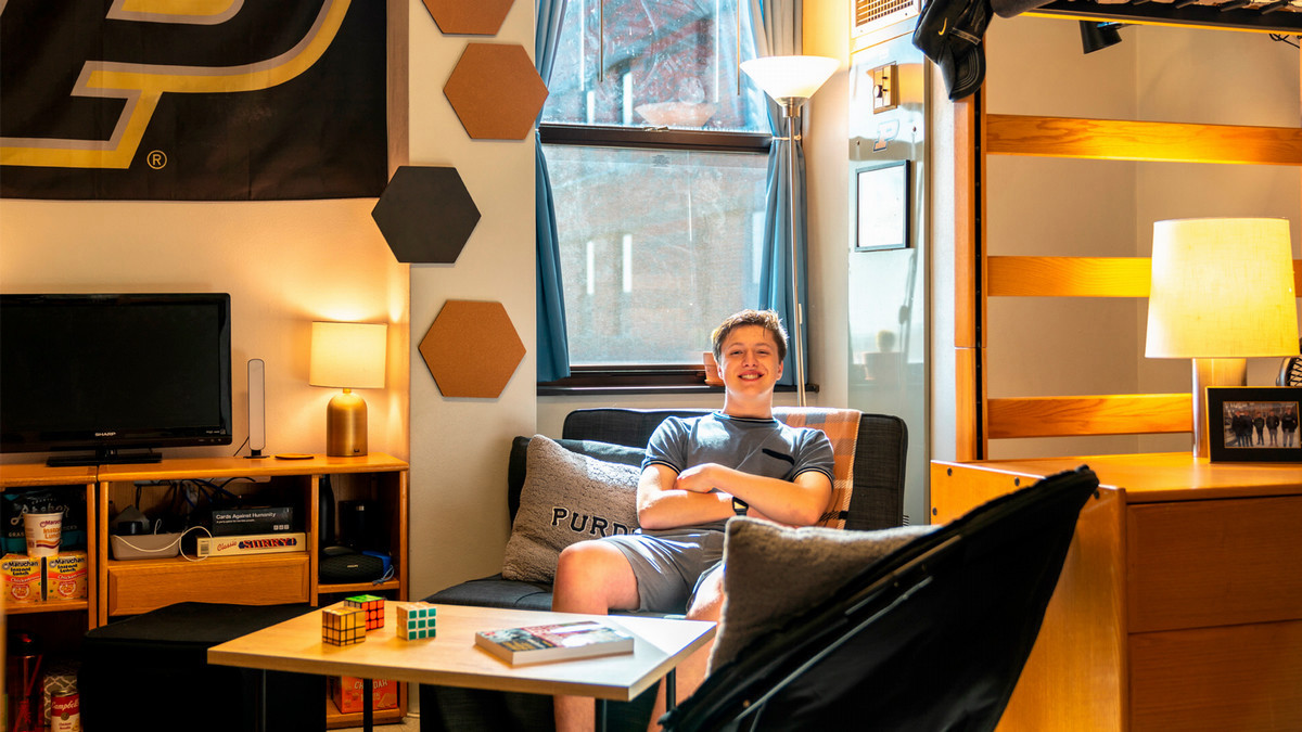 A student sitting in his dorm room.