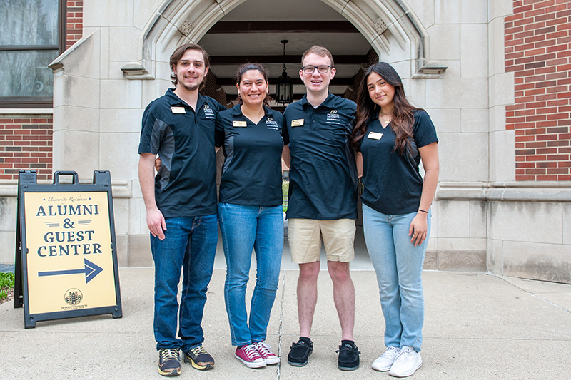 Student Conductors in front of the Alumni and Guest Center