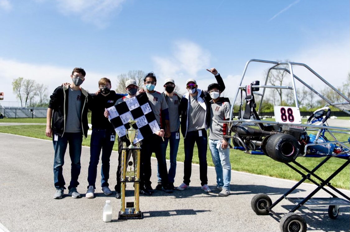 Members of Cavalry Racing pose with trophy and kart after winning the 64th running of the Purdue Grand Prix.