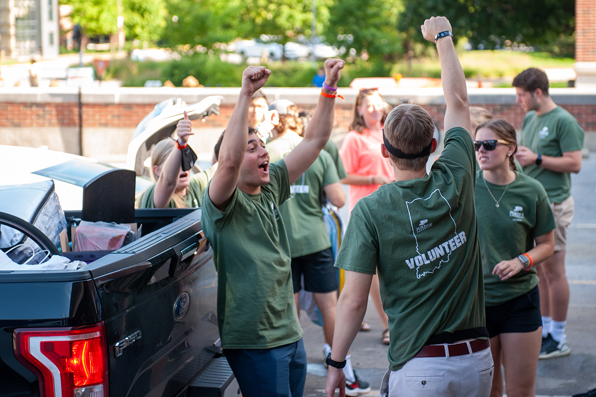 Student volunteers celebrate another arrival.