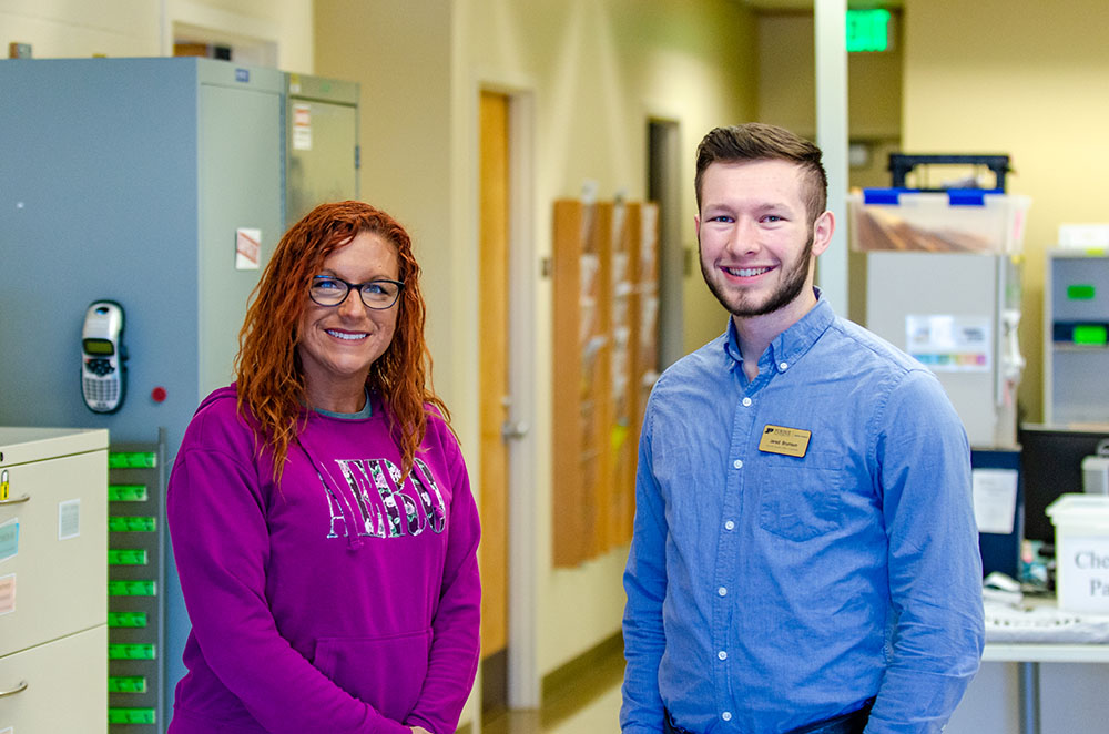 Brittany Madden, student office coordinator and staff supervisor, and Jared Brunson, student office coordinator, during fall 2021.