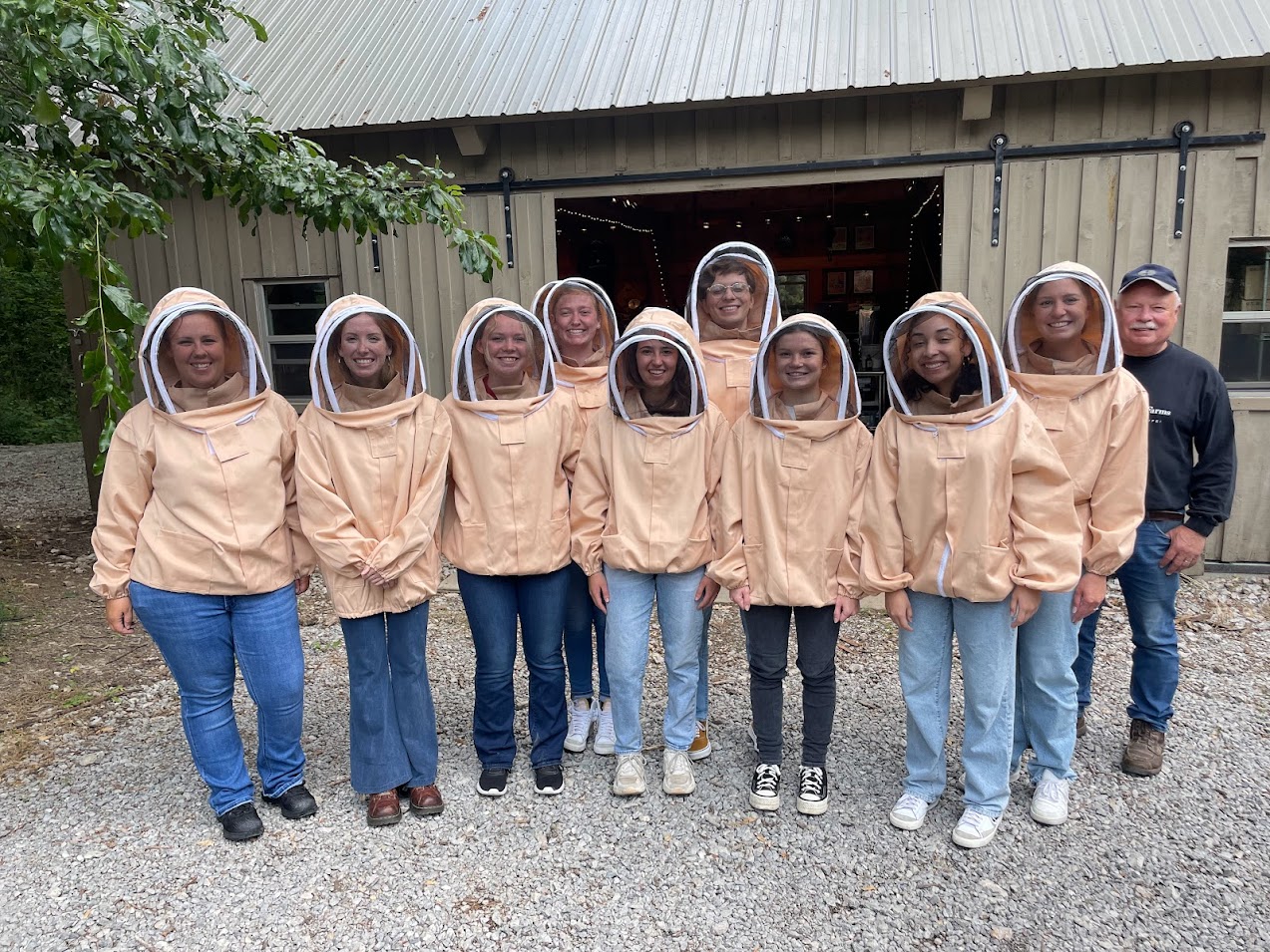 Interns in beekeeping suits.