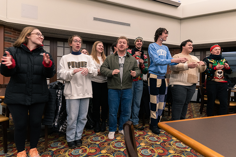 Students from PMO perform Christmas carols in Hillenbrand Dining Court.