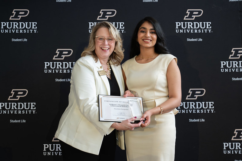 Smiling student receives award